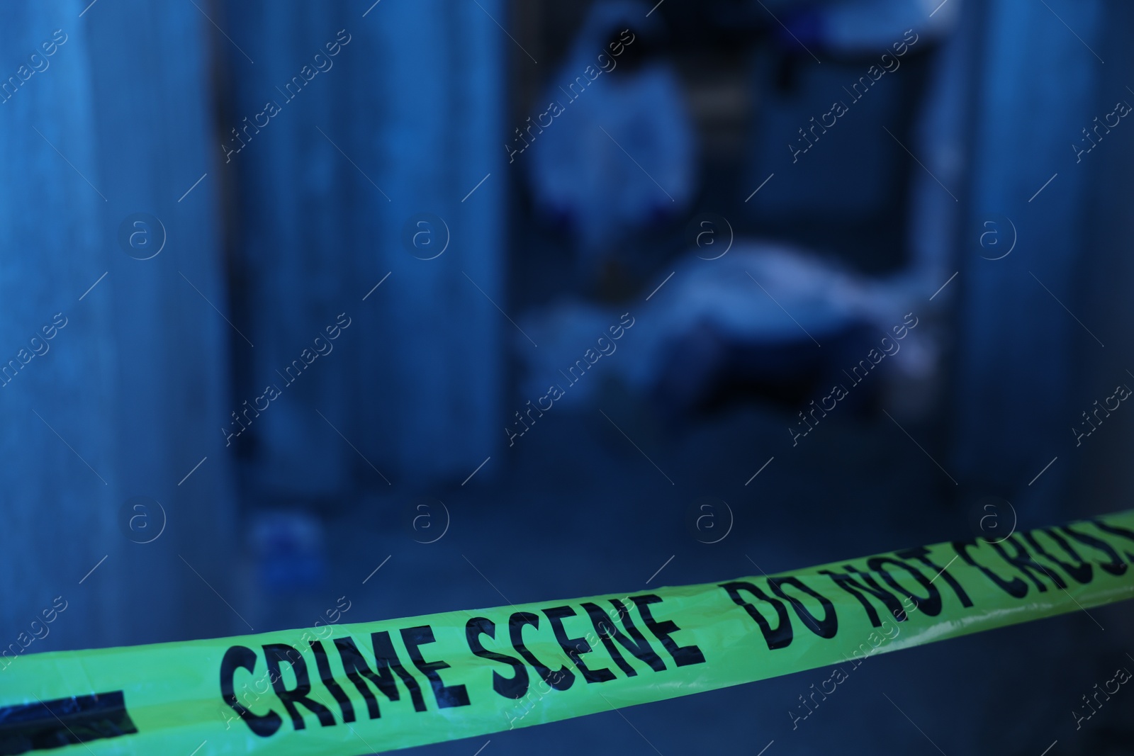 Forensic experts working at crime scene with dead body inside abandoned building, focus on yellow police tape Photo of Forensic experts working at crime scene with dead body inside abandoned building, focus on yellow police tape