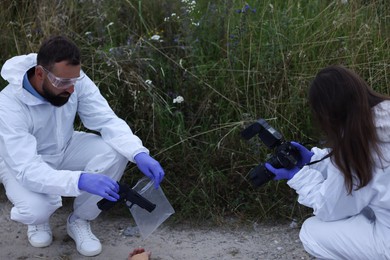 Photo of Forensic experts working at crime scene outdoors