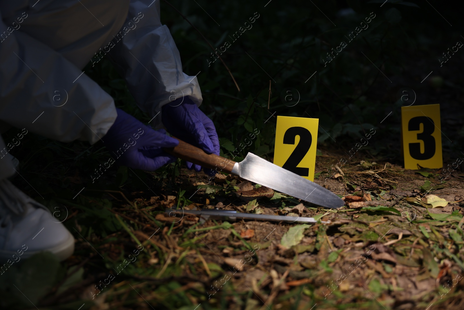 Photo of Forensic expert working at crime scene outdoors, closeup
