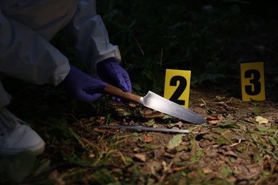 Photo of Forensic expert working at crime scene outdoors, closeup