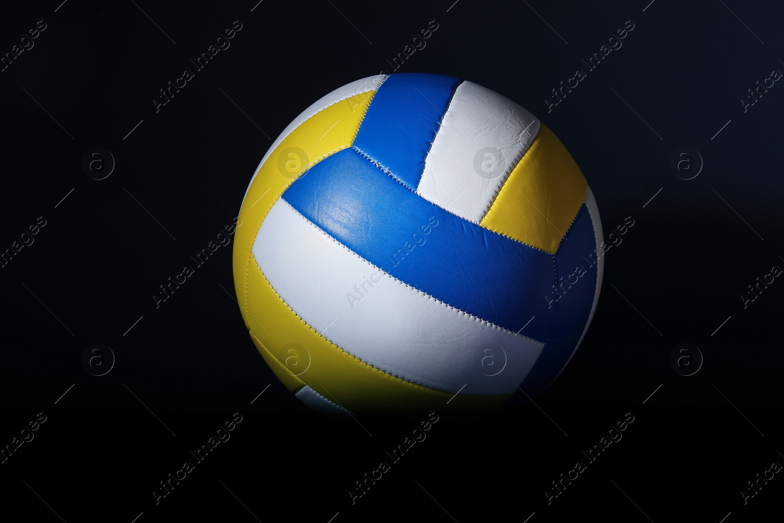 Photo of One volleyball ball on black background. Sports equipment