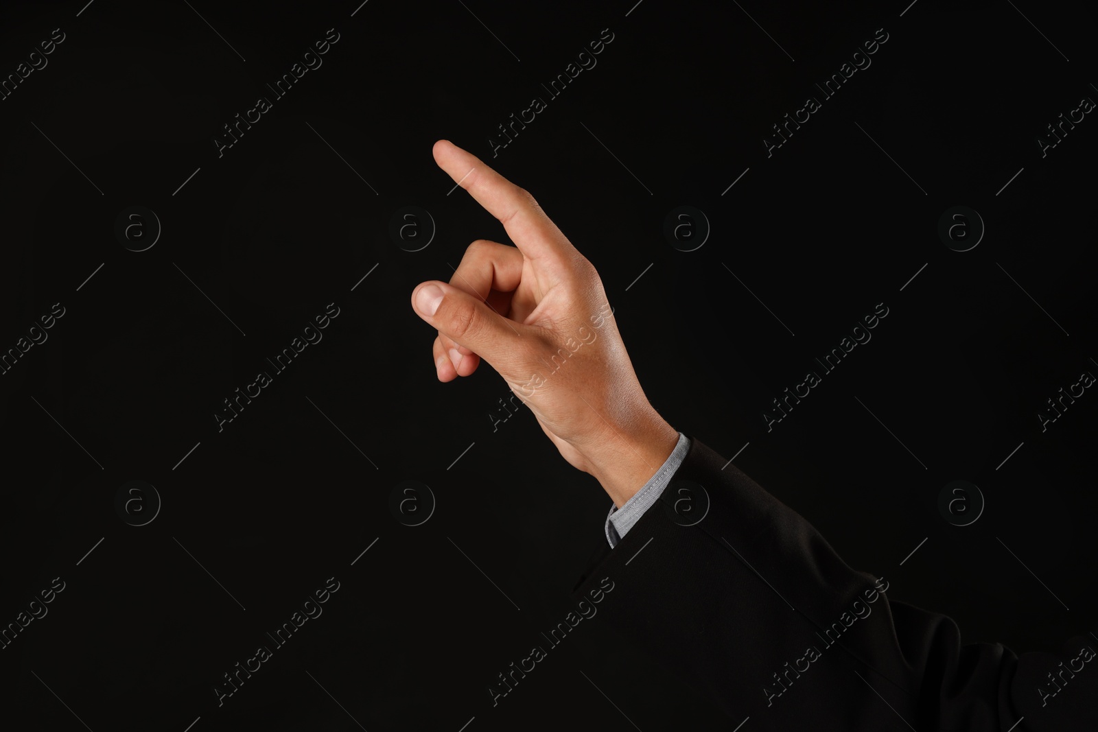 Man touching something on black background, closeup. Space for text Photo of Man touching something on black background, closeup. Space for text