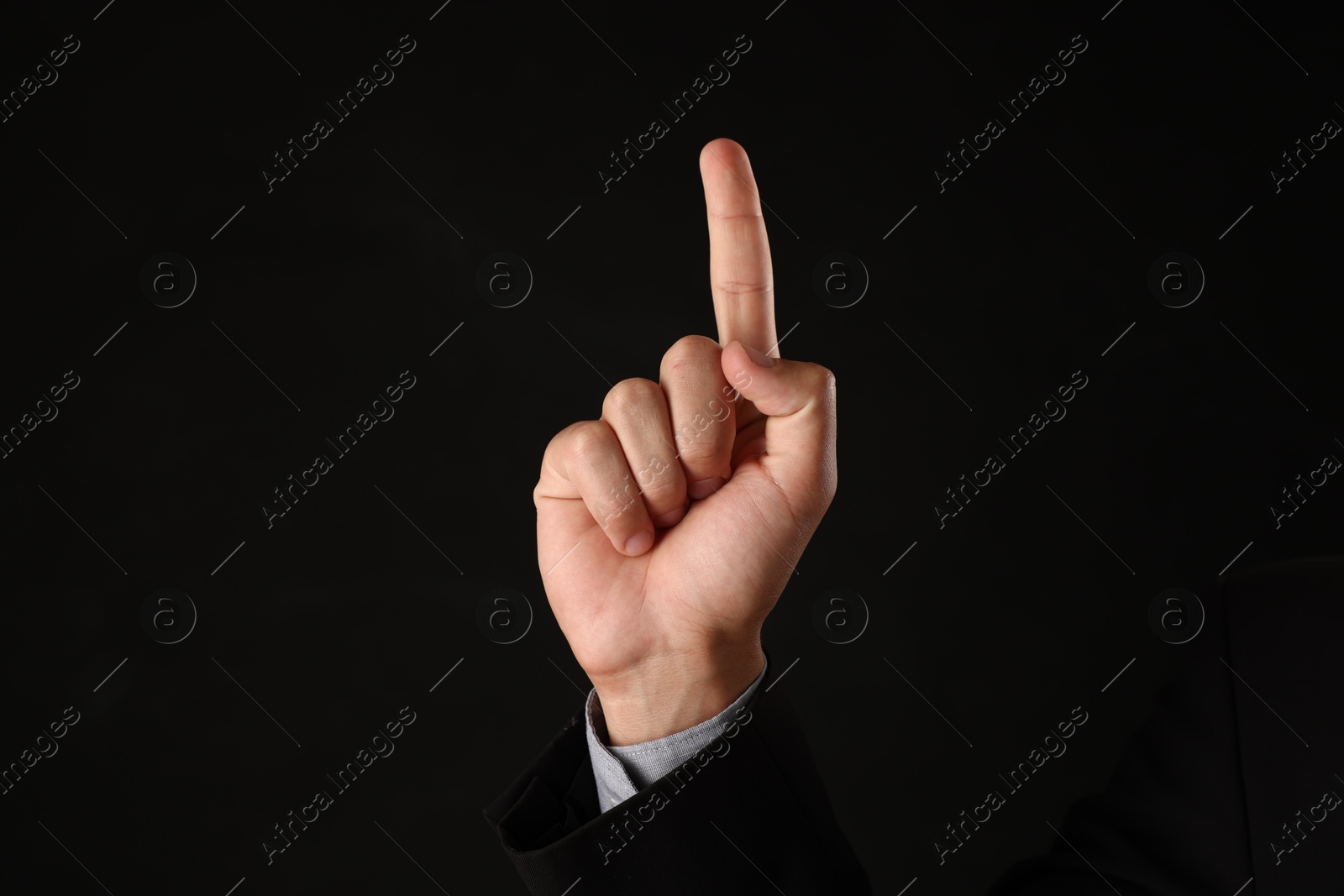 Man touching something on black background, closeup Photo of Man touching something on black background, closeup