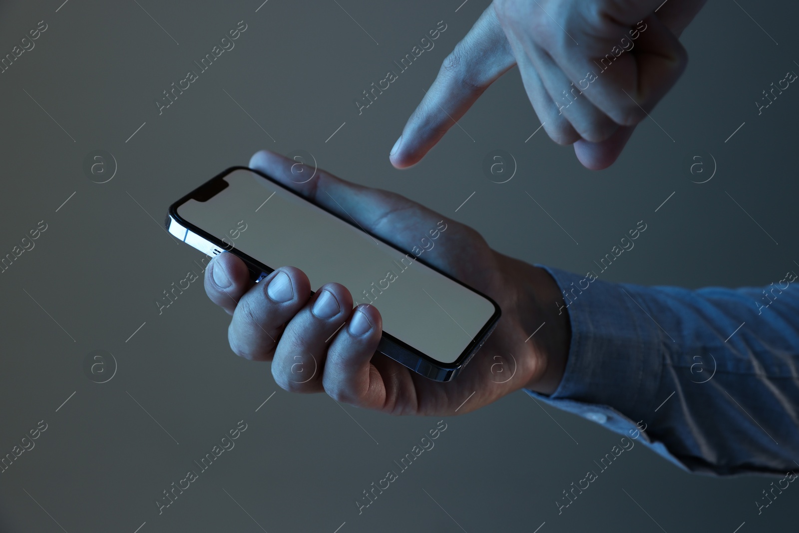 Man with modern smartphone on grey background, closeup. Mockup for design Photo of Man with modern smartphone on grey background, closeup. Mockup for design