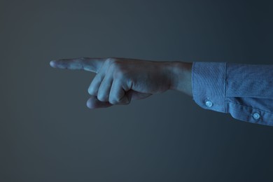 Photo of Man touching something on grey background, closeup