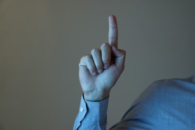 Photo of Man touching something on grey background, closeup