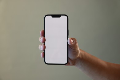 Photo of Man with modern smartphone on grey background, closeup. Mockup for design