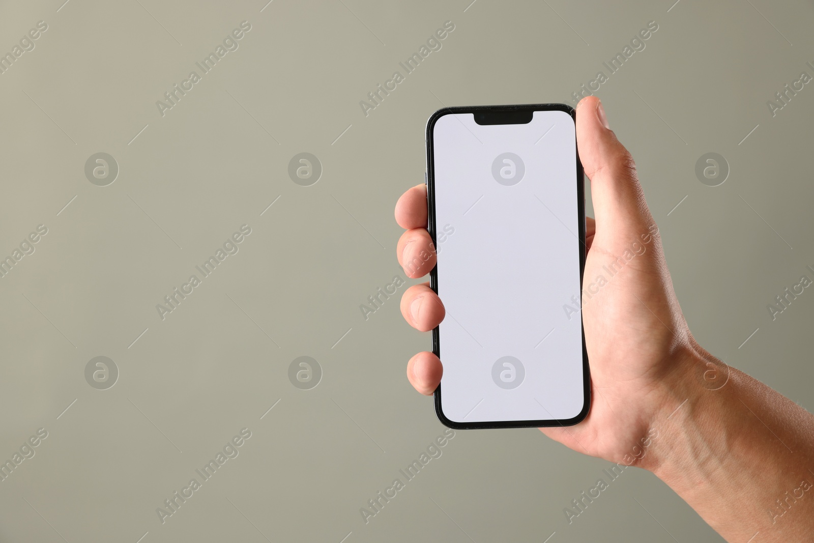 Man with modern smartphone on beige grey background, closeup. Mockup for design Photo of Man with modern smartphone on beige grey background, closeup. Mockup for design
