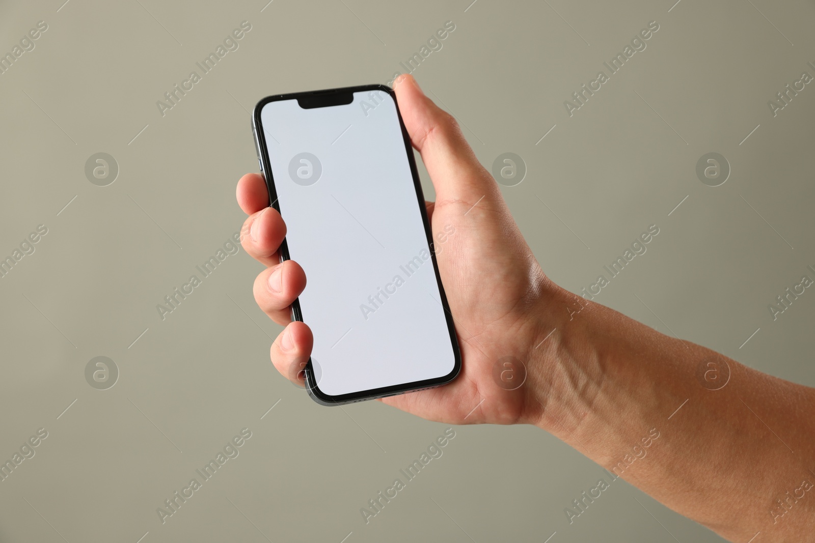 Man with modern smartphone on beige grey background, closeup. Mockup for design Photo of Man with modern smartphone on beige grey background, closeup. Mockup for design