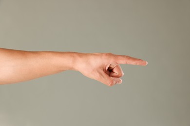 Photo of Man touching something on light grey background, closeup