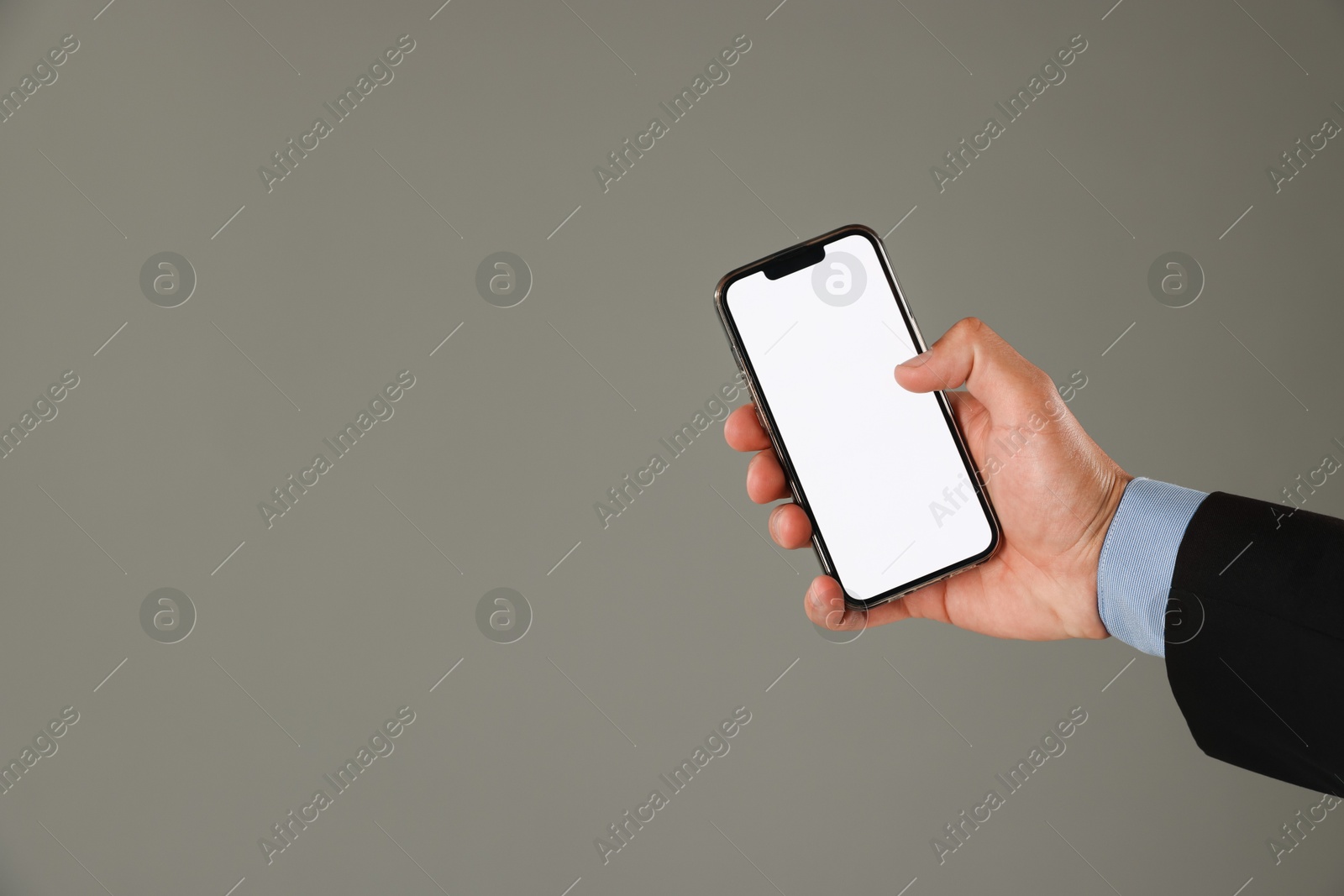 Man with modern smartphone on grey background, closeup. Mockup for design Photo of Man with modern smartphone on grey background, closeup. Mockup for design