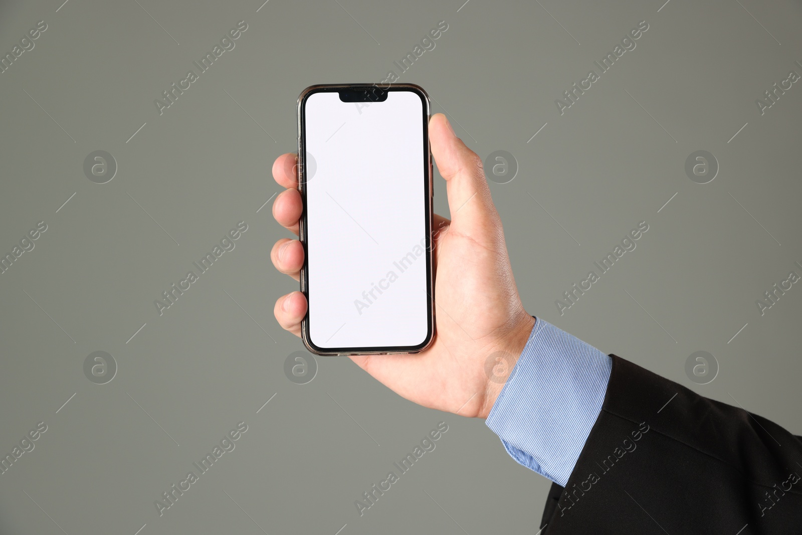 Man with modern smartphone on grey background, closeup. Mockup for design Photo of Man with modern smartphone on grey background, closeup. Mockup for design