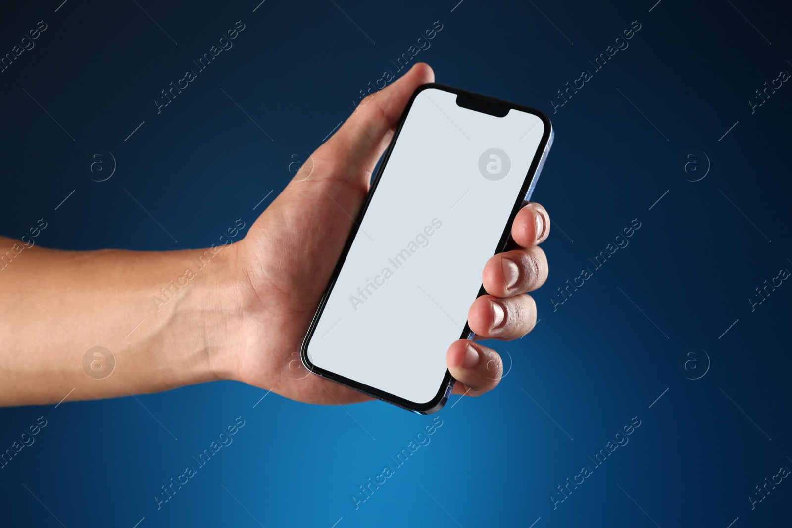 Man with modern smartphone on blue background, closeup. Mockup for design Photo of Man with modern smartphone on blue background, closeup. Mockup for design