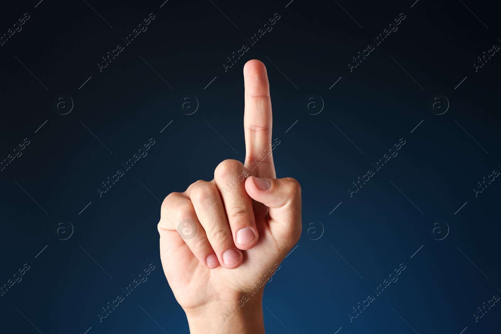 Photo of Man touching something on blue background, closeup