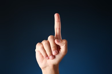 Photo of Man touching something on blue background, closeup
