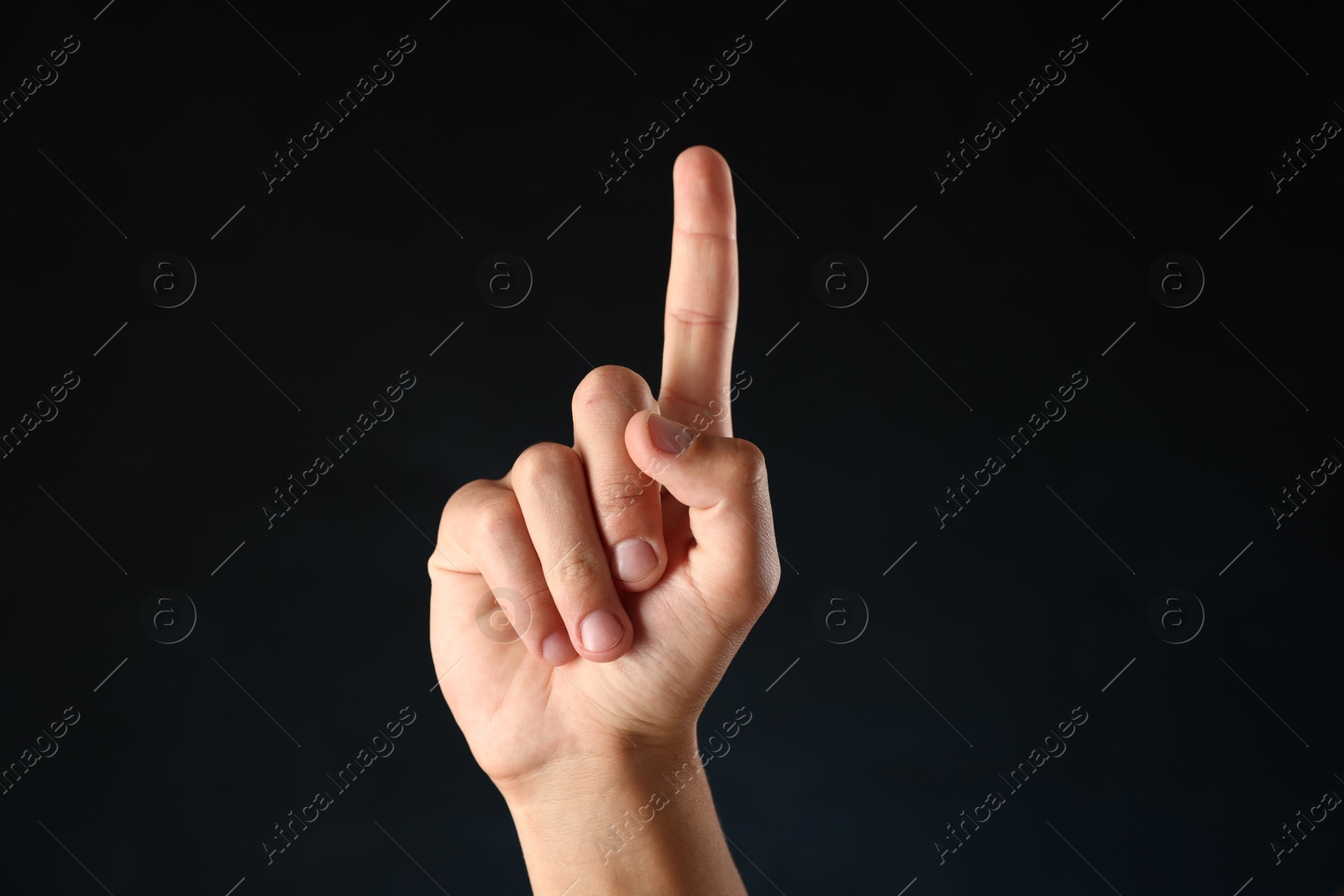 Man touching something on black background, closeup Photo of Man touching something on black background, closeup