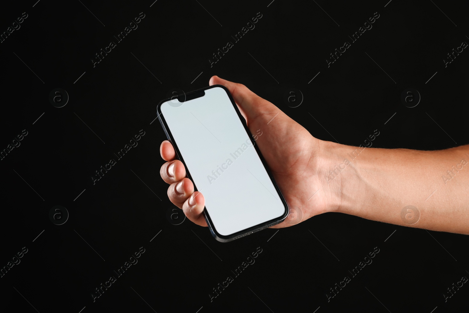 Man with modern smartphone on black background, closeup. Mockup for design Photo of Man with modern smartphone on black background, closeup. Mockup for design