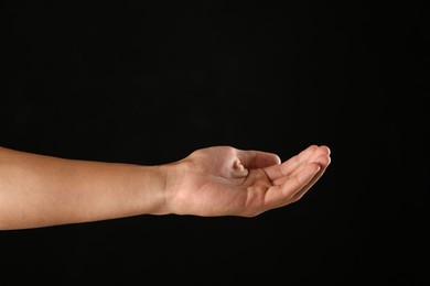 Photo of Man holding something on black background, closeup