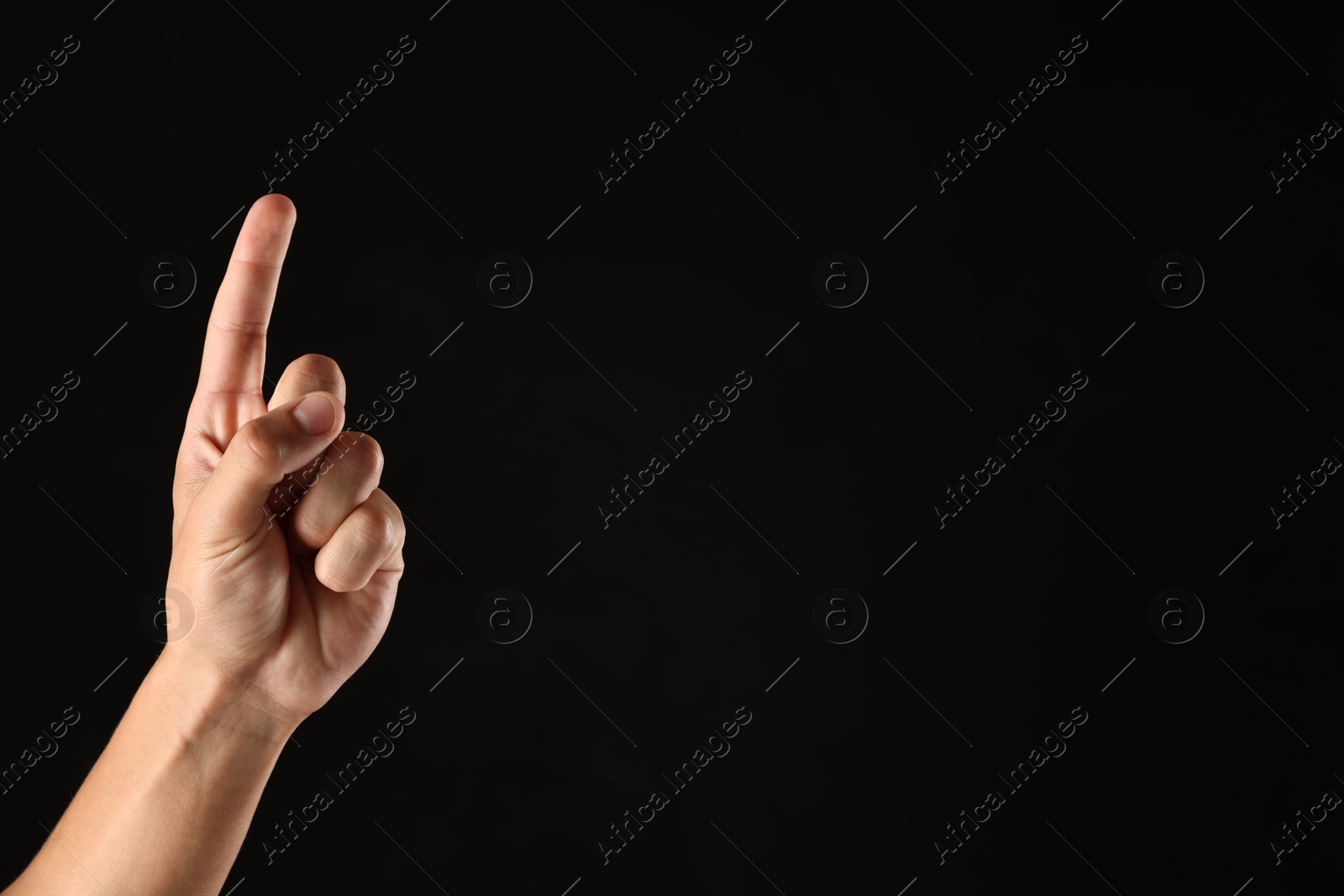Man touching something on black background, closeup. Space for text Photo of Man touching something on black background, closeup. Space for text