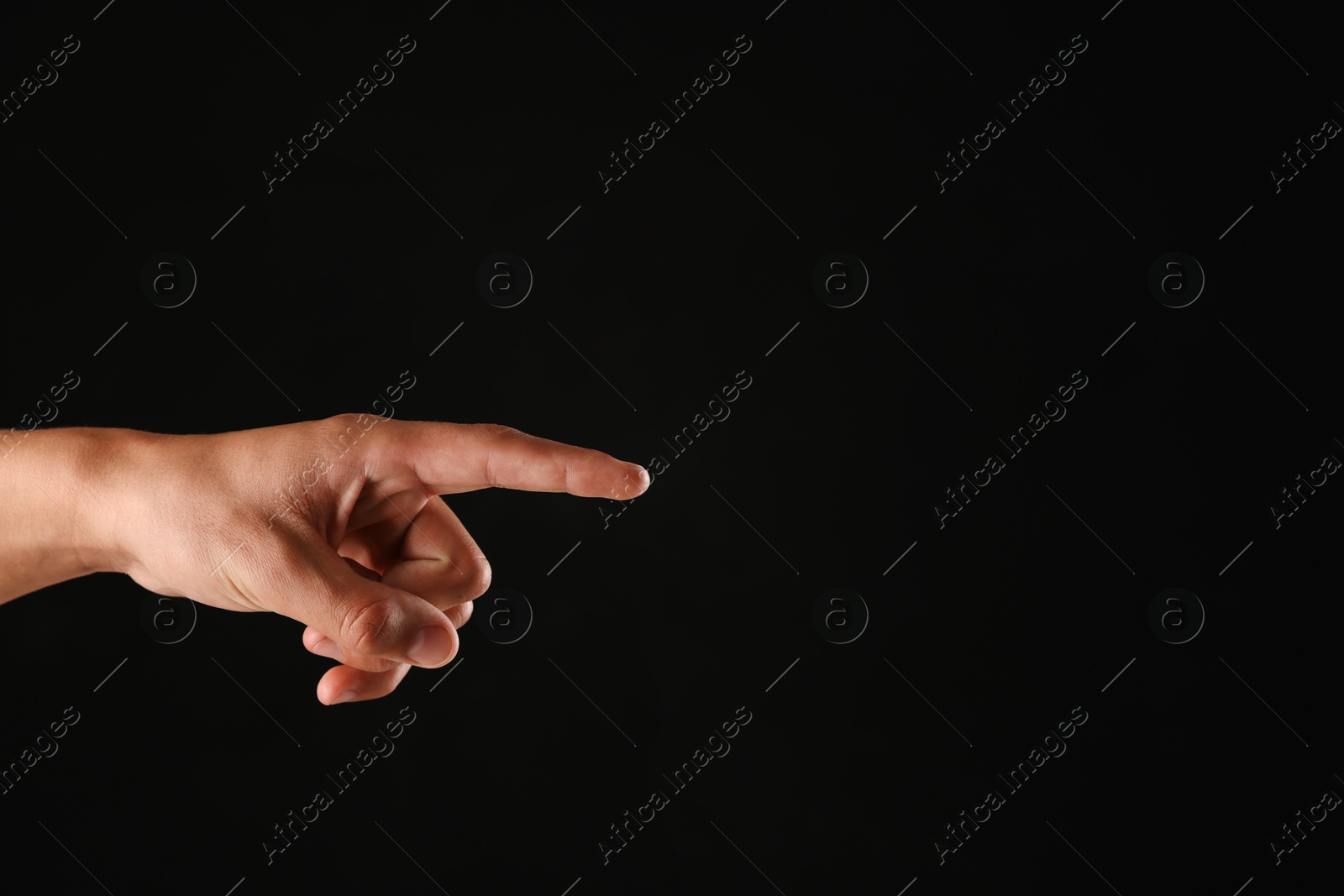 Man touching something on black background, closeup. Space for text Photo of Man touching something on black background, closeup. Space for text