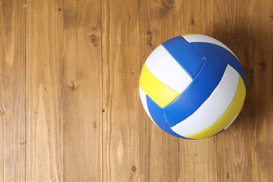 Photo of One volleyball ball on wooden surface, top view. Space for text