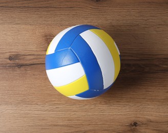 Photo of One volleyball ball on wooden surface, top view