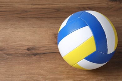 Photo of One volleyball ball on wooden surface, top view. Space for text