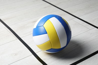 Photo of One volleyball ball on floor, closeup. Sports equipment