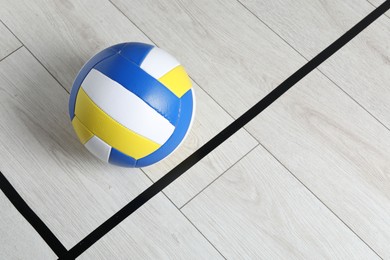 Photo of One volleyball ball on floor, top view. Space for text