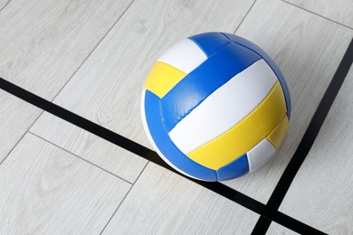 Photo of One volleyball ball on floor, above view. Space for text