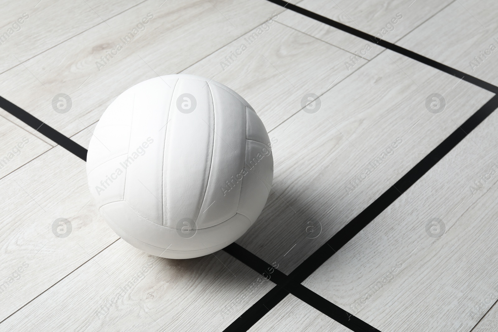 One volleyball ball on floor, space for text Photo of One volleyball ball on floor, space for text