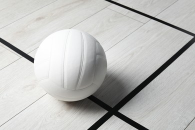 Photo of One volleyball ball on floor, space for text