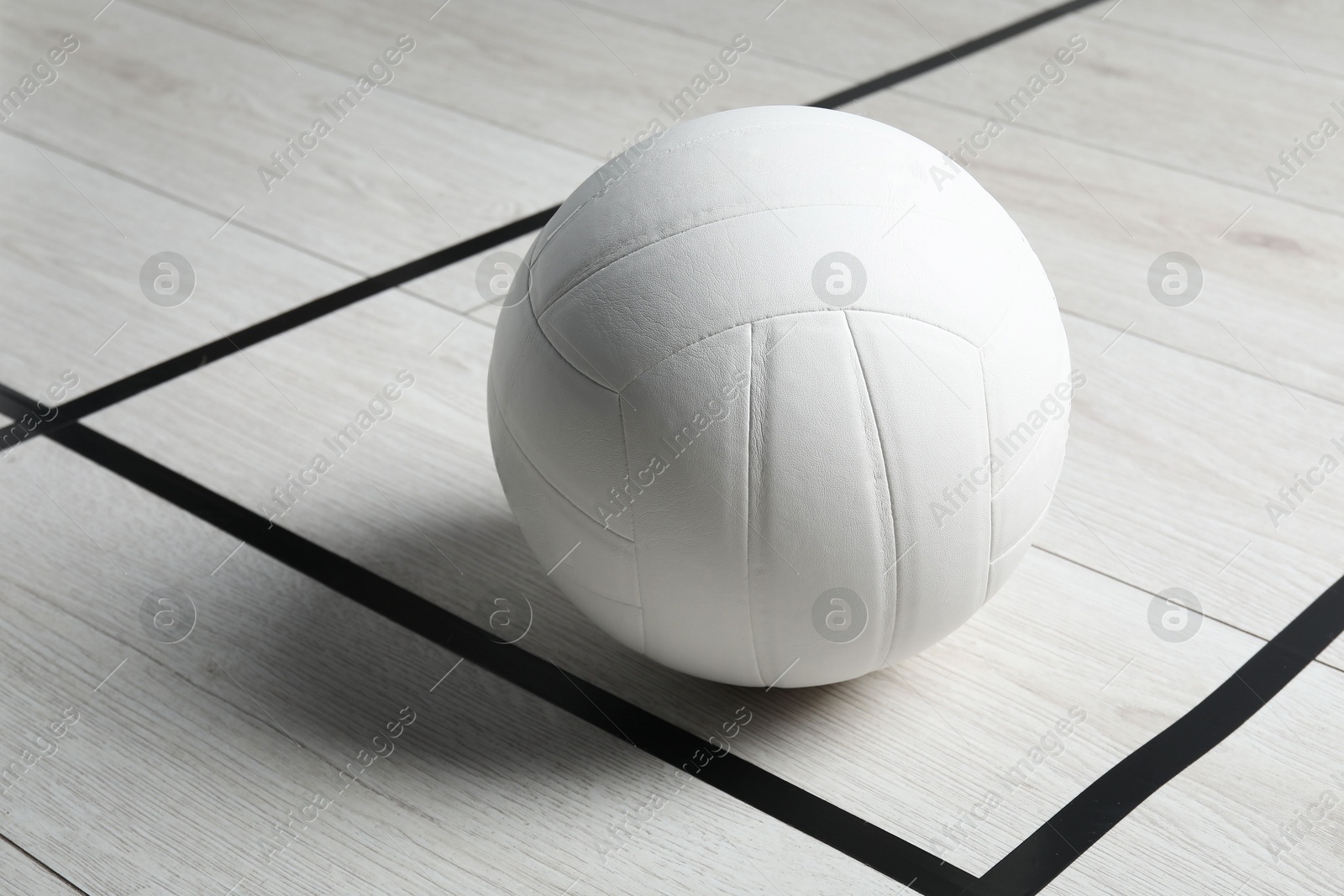 One volleyball ball on floor, closeup. Space for text Photo of One volleyball ball on floor, closeup. Space for text