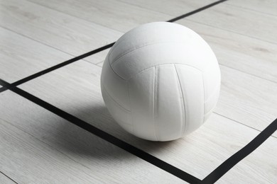 Photo of One volleyball ball on floor, closeup. Space for text