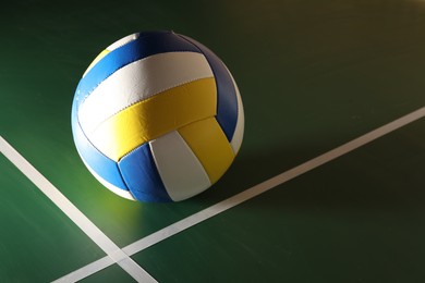 Photo of One volleyball ball on court, space for text