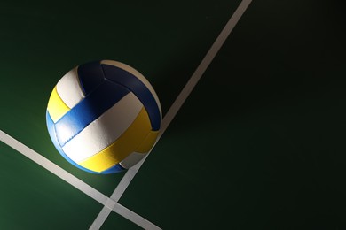 Photo of One volleyball ball on court, top view. Space for text