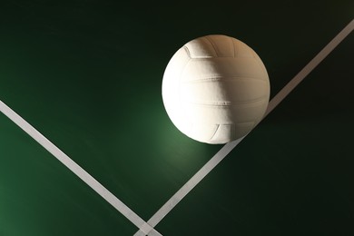 Photo of One volleyball ball on court, top view. Space for text