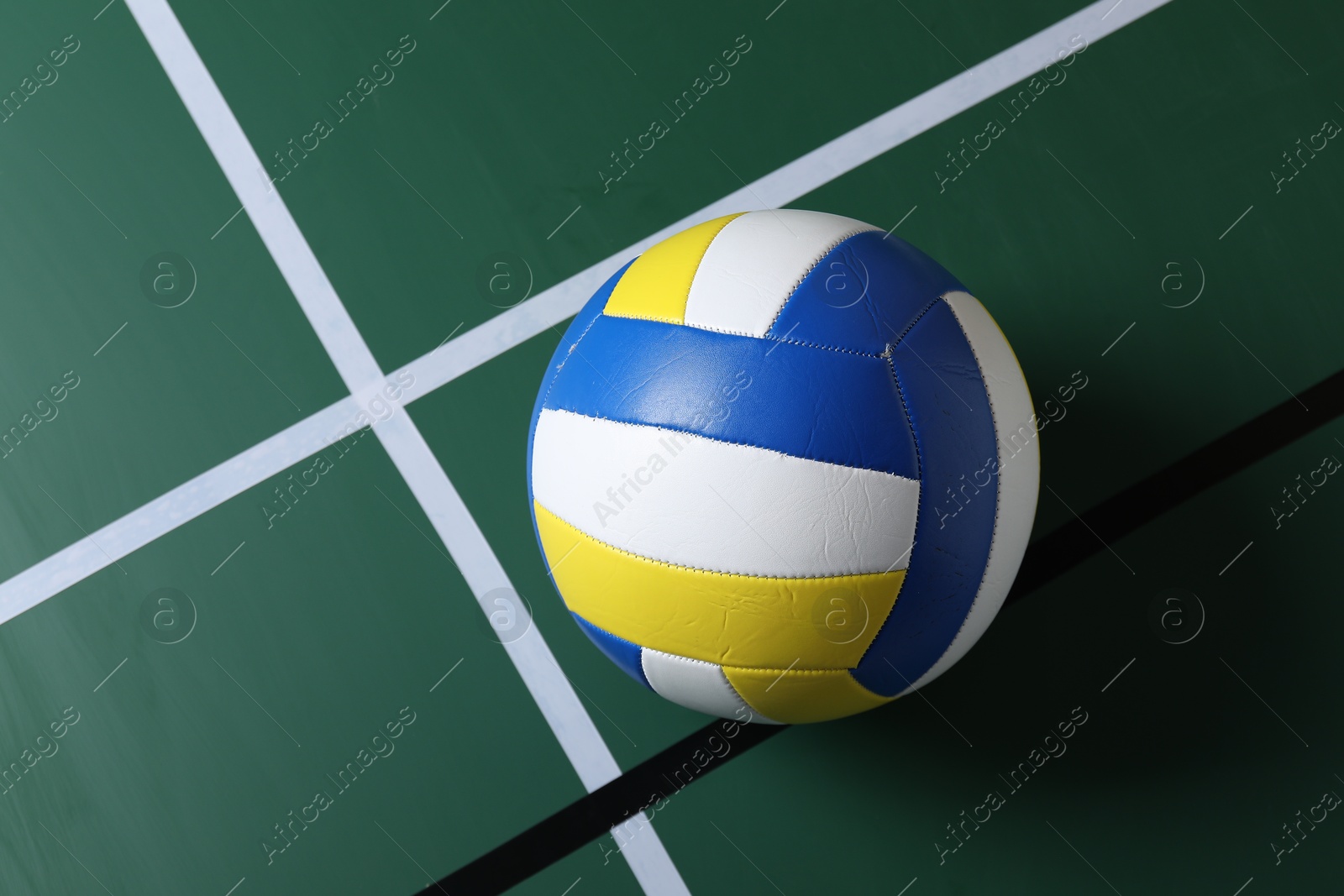One volleyball ball on court, top view. Space for text Photo of One volleyball ball on court, top view. Space for text