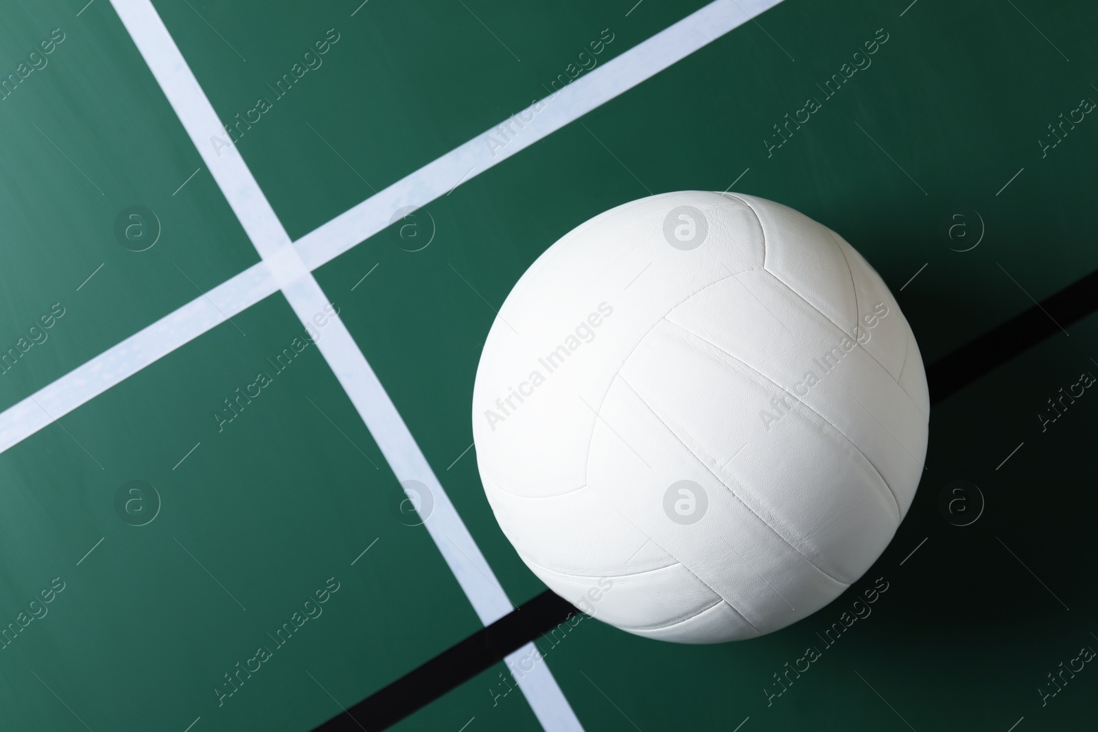 One volleyball ball on court, top view. Space for text Photo of One volleyball ball on court, top view. Space for text