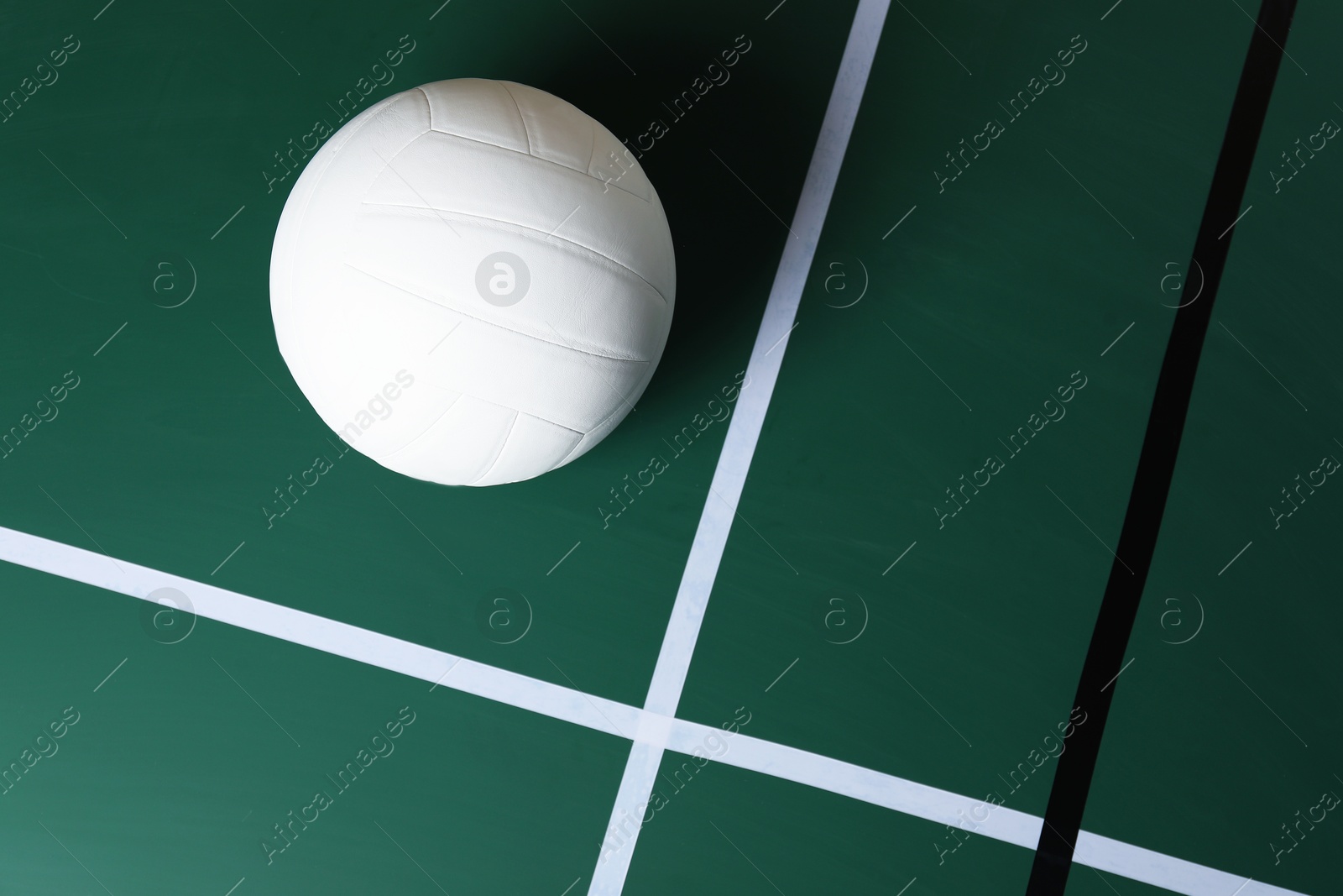 One volleyball ball on court, top view. Space for text Photo of One volleyball ball on court, top view. Space for text