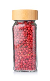 Photo of Red peppercorns in glass jar isolated on white. Aromatic spice