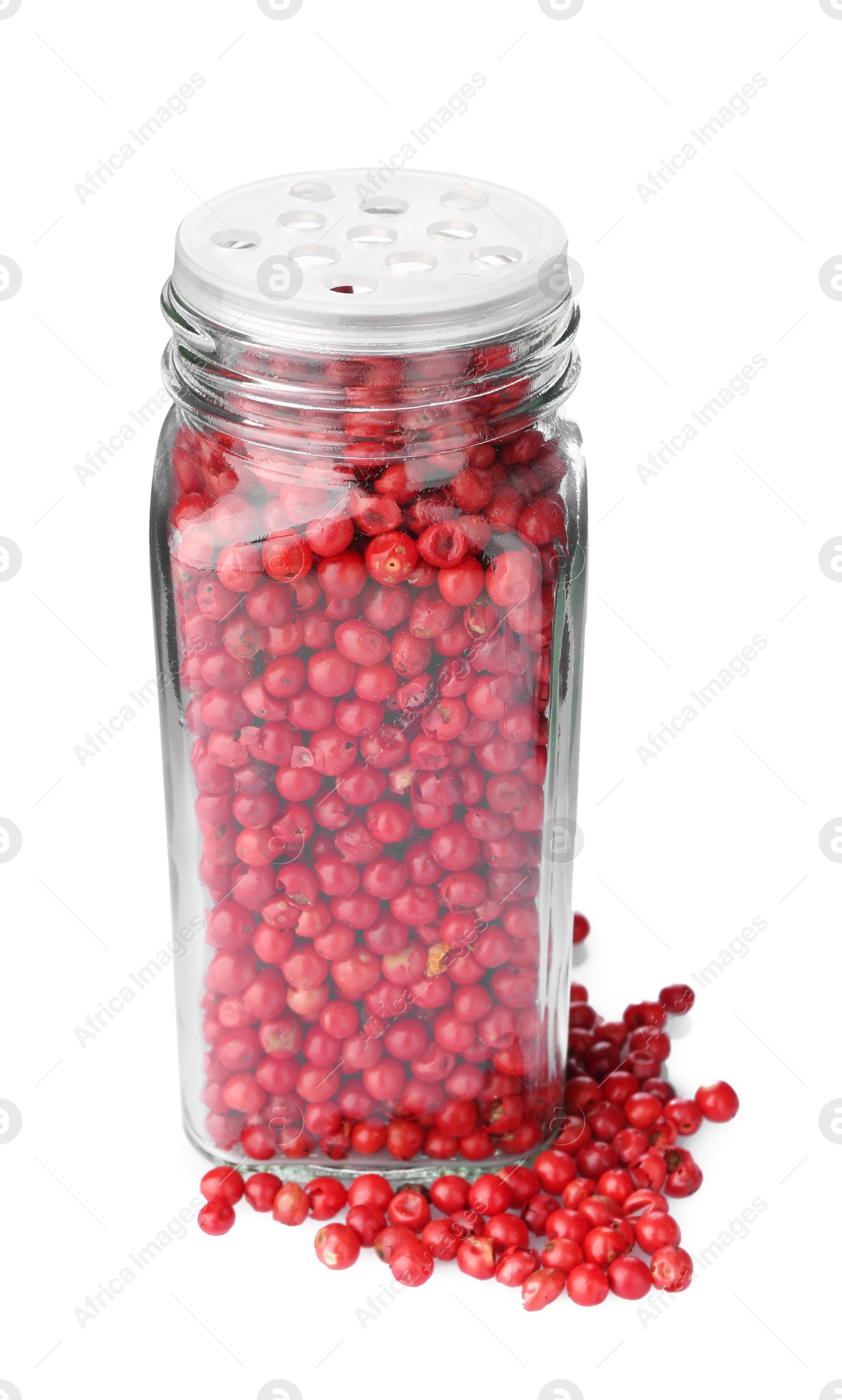 Photo of Red peppercorns in glass jar isolated on white. Aromatic spice