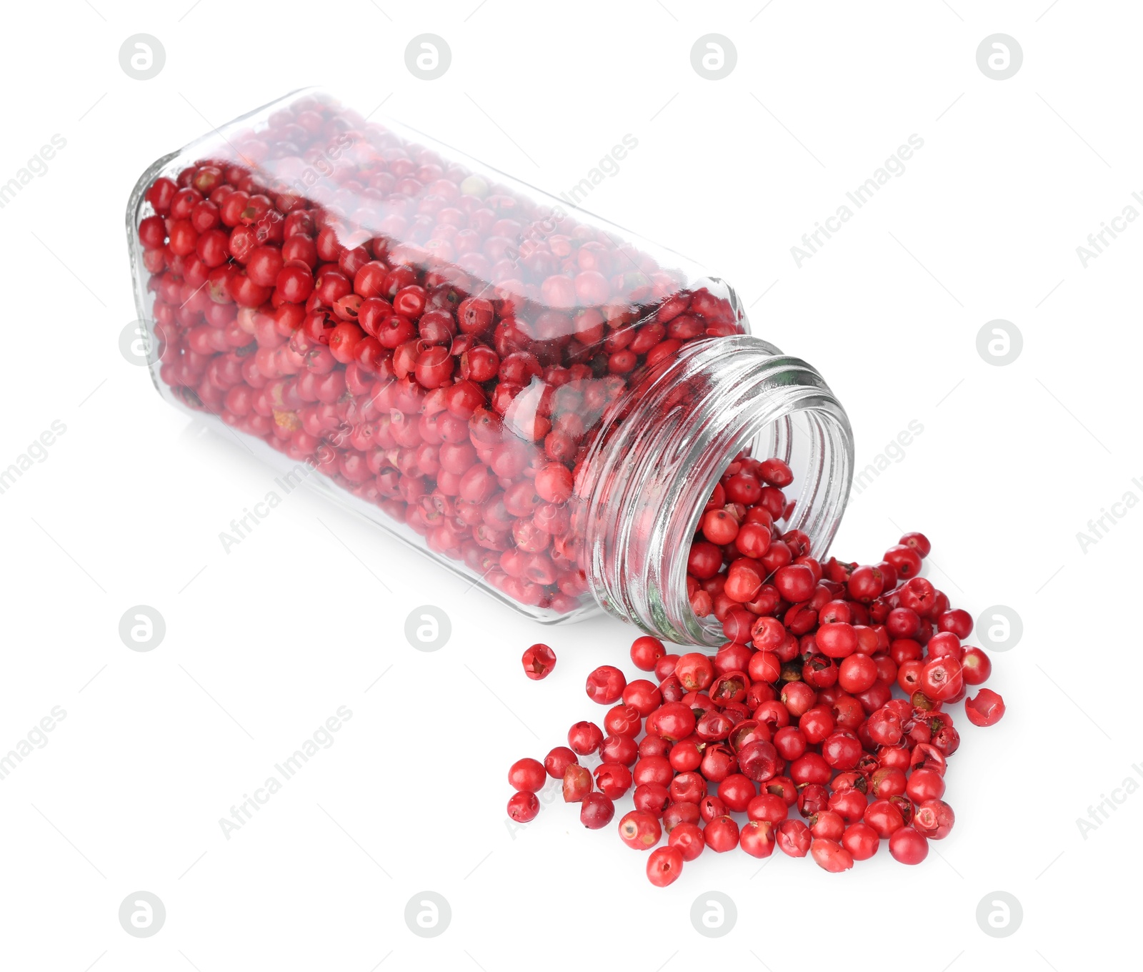 Photo of Red peppercorns in glass jar isolated on white. Aromatic spice