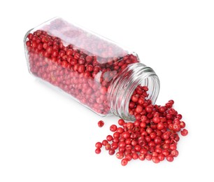 Photo of Red peppercorns in glass jar isolated on white. Aromatic spice