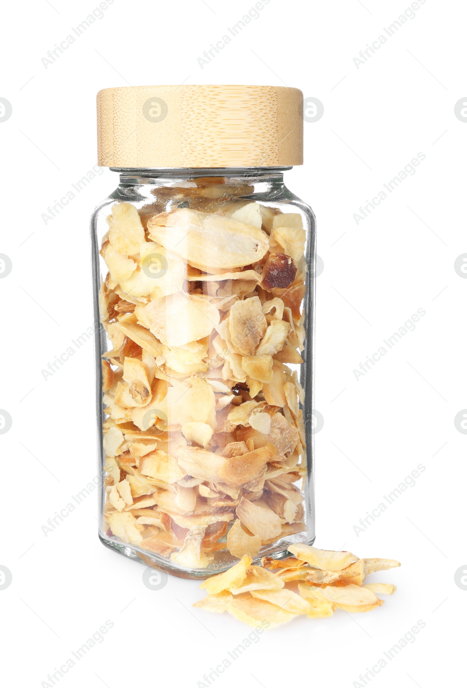 Photo of Dried garlic flakes in glass jar isolated on white. Aromatic spice