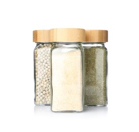 Photo of Different aromatic spices in glass jars isolated on white