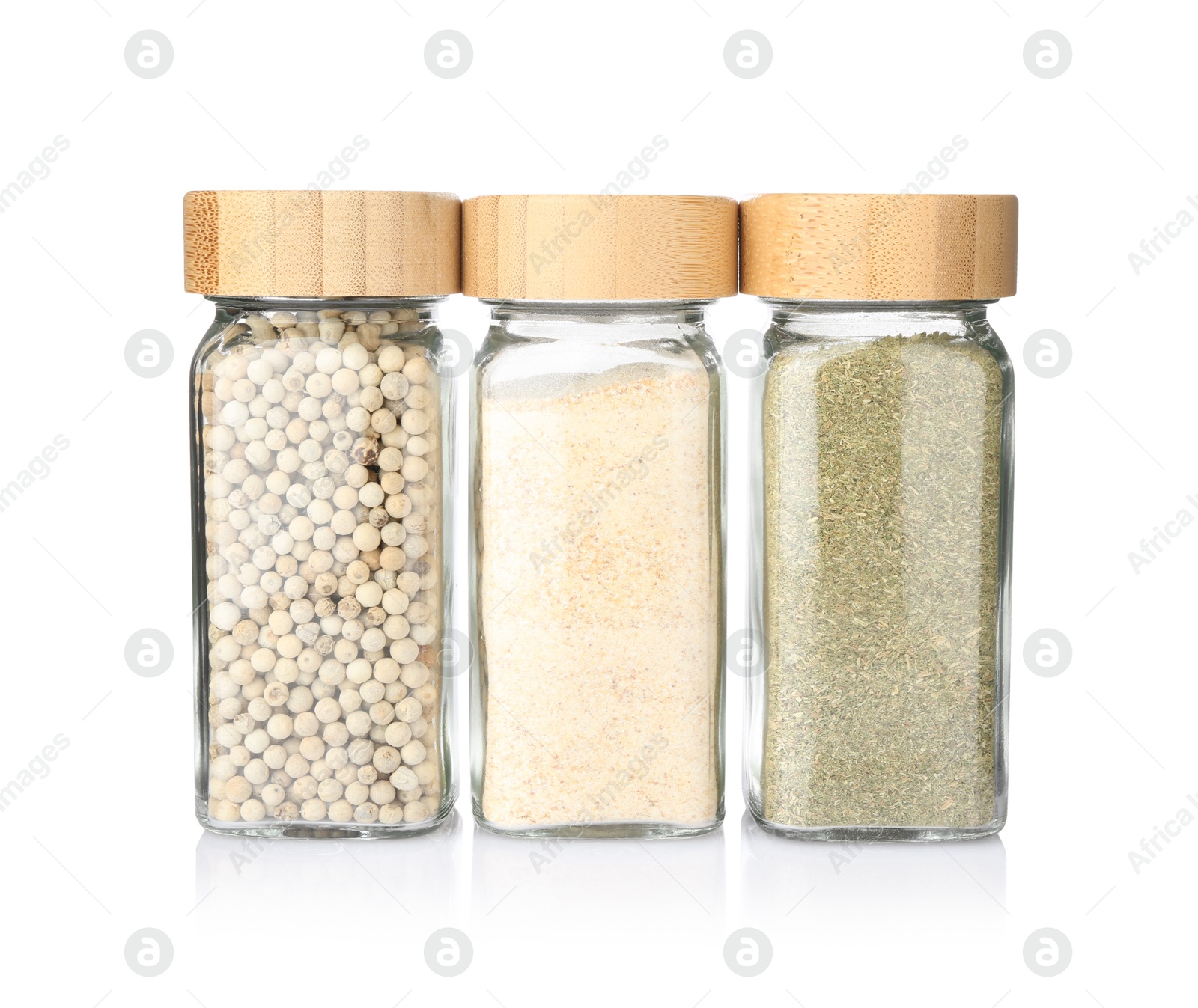 Different aromatic spices in glass jars isolated on white Photo of Different aromatic spices in glass jars isolated on white