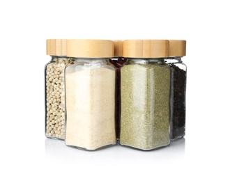 Photo of Different aromatic spices in glass jars isolated on white