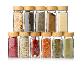 Photo of Different aromatic spices in glass jars isolated on white