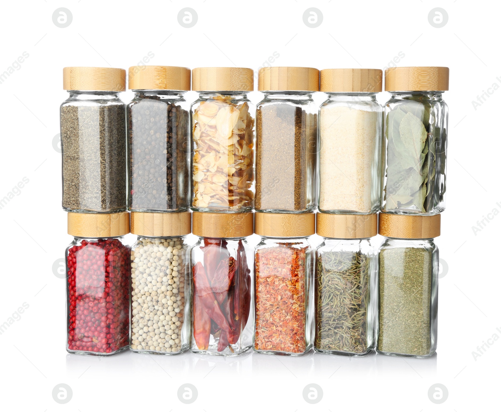 Photo of Different aromatic spices in glass jars isolated on white